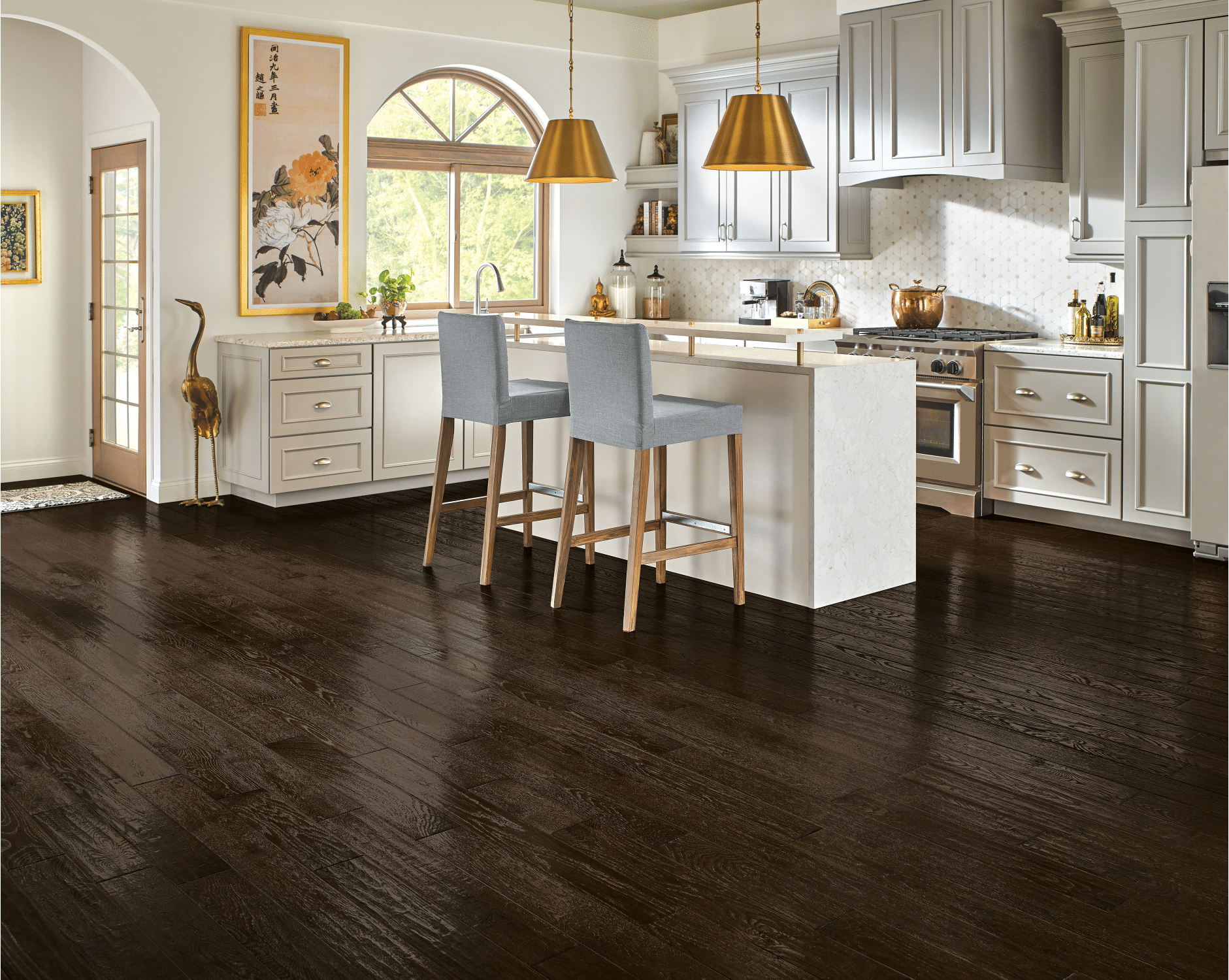 A kitchen with dark luxury vinyl plank floors.