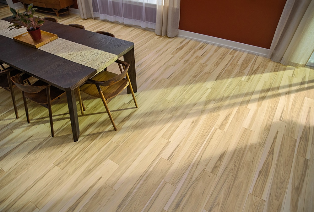 Light colored laminate flooring in a dining room.